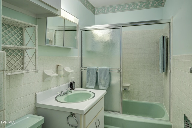 600 Valley Ave, Erwin, TN 37650 - full bath featuring tile walls, toilet, vanity, bath / shower combo with glass door, and wainscoting