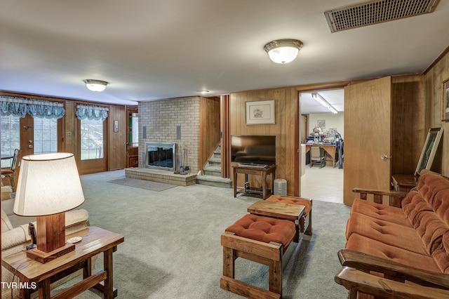 600 Valley Ave, Erwin, TN 37650 - carpeted living room with a fireplace, wood walls, and visible vents