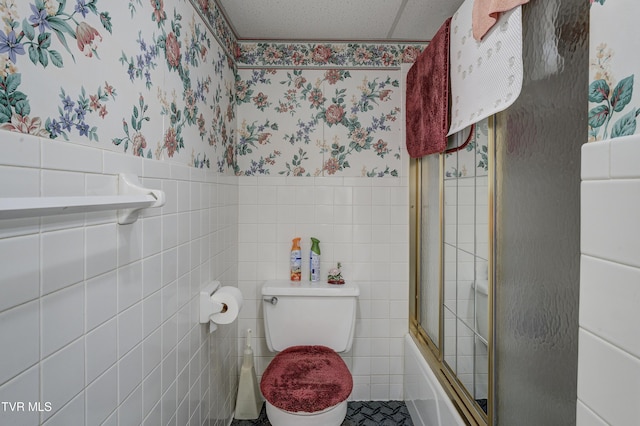 600 Valley Ave, Erwin, TN 37650 - full bathroom with toilet, shower / bath combination with glass door, wallpapered walls, tile walls, and wainscoting