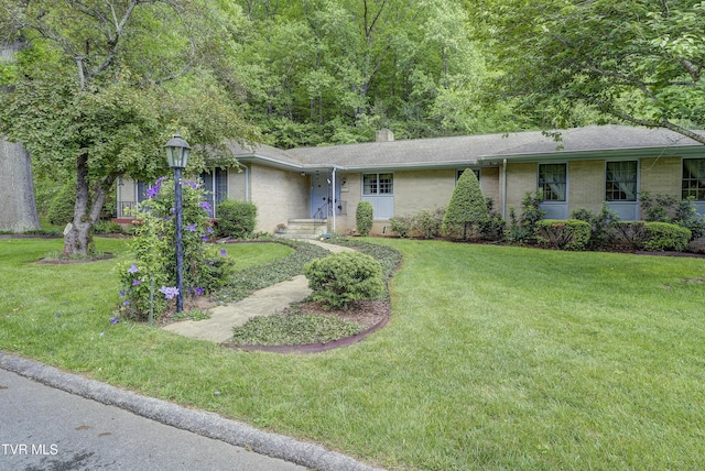 600 Valley Ave, Erwin, TN 37650 - ranch-style home featuring a chimney, brick siding, and a front lawn