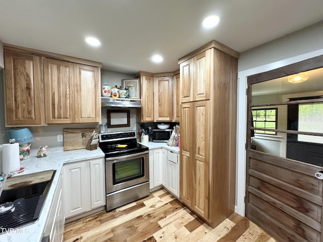 3401 Fairfax Rd, Coeburn, VA 24230 - kitchen featuring stainless steel range with electric cooktop, under cabinet range hood, light wood-type flooring, a sink, and light stone counters