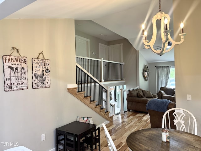 3401 Fairfax Rd, Coeburn, VA 24230 - dining room featuring wood finished floors, a chandelier, lofted ceiling, and stairway