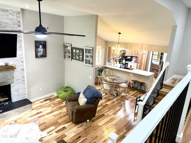 3401 Fairfax Rd, Coeburn, VA 24230 - living area with wood finished floors, a stone fireplace, lofted ceiling, a chandelier, and ceiling fan