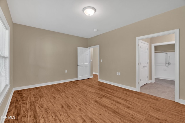 unfurnished bedroom featuring baseboards and wood finished floors