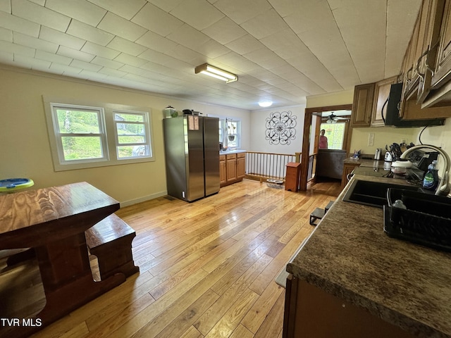 7311 Rocky Fork Rd, Wise, VA 24293 - kitchen featuring freestanding refrigerator, dark countertops, light wood-type flooring, and a sink