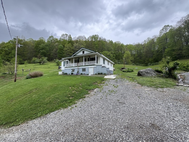 7311 Rocky Fork Rd, Wise, VA 24293 - view of front of property featuring a garage, a view of trees, a front yard, a porch, and driveway