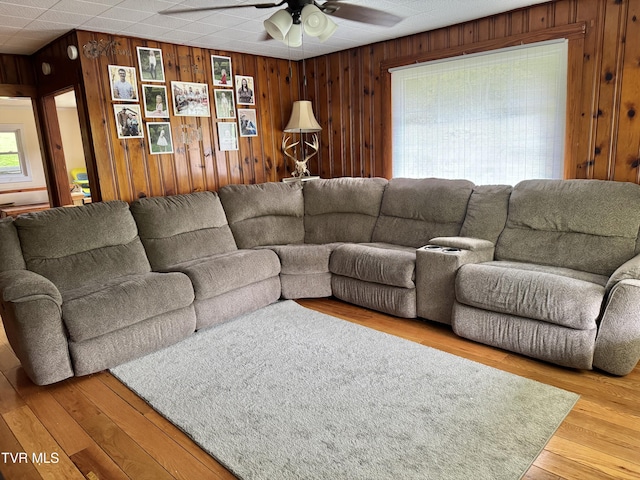 7311 Rocky Fork Rd, Wise, VA 24293 - living room with wood walls, a wealth of natural light, a ceiling fan, and wood finished floors