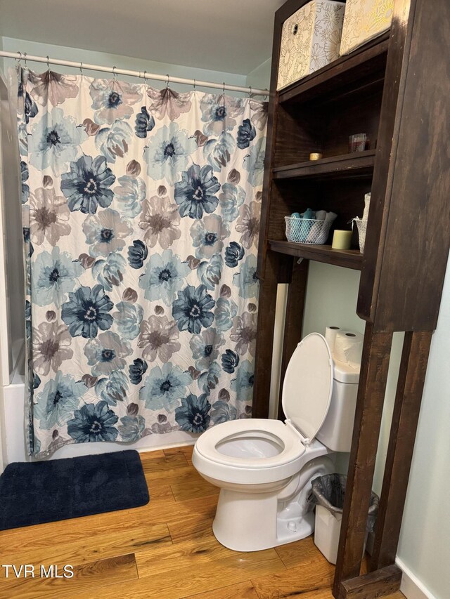 7311 Rocky Fork Rd, Wise, VA 24293 - bathroom featuring toilet, baseboards, shower / tub combo, and wood finished floors