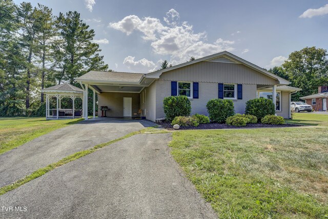 2405 Larkspur Dr, Johnson City, TN 37604 - ranch-style home featuring a front lawn, an attached carport, brick siding, and aphalt driveway