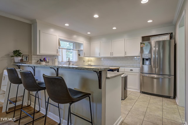 2405 Larkspur Dr, Johnson City, TN 37604 - kitchen featuring a peninsula, crown molding, white cabinetry, and stainless steel fridge