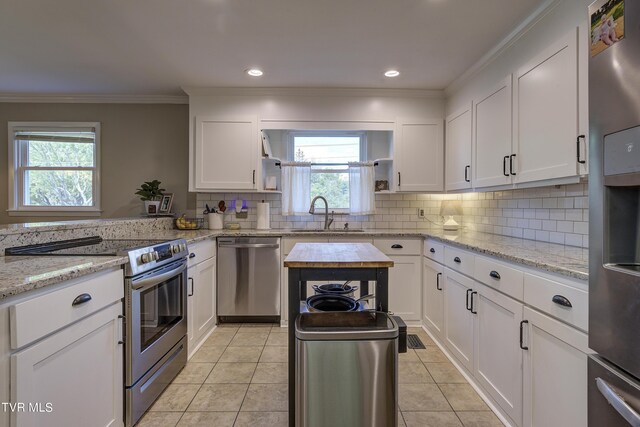 2405 Larkspur Dr, Johnson City, TN 37604 - kitchen with a sink, white cabinetry, decorative backsplash, and appliances with stainless steel finishes