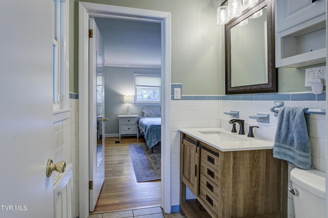 2405 Larkspur Dr, Johnson City, TN 37604 - bathroom featuring toilet, tile walls, vanity, and a wainscoted wall