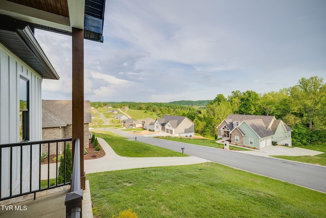 view of green lawn featuring a residential view