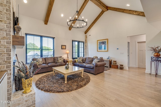 living area with high vaulted ceiling, beam ceiling, a chandelier, light wood-style floors, and plenty of natural light