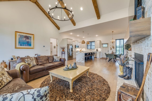 living area with a chandelier, beam ceiling, high vaulted ceiling, light wood-style floors, and recessed lighting