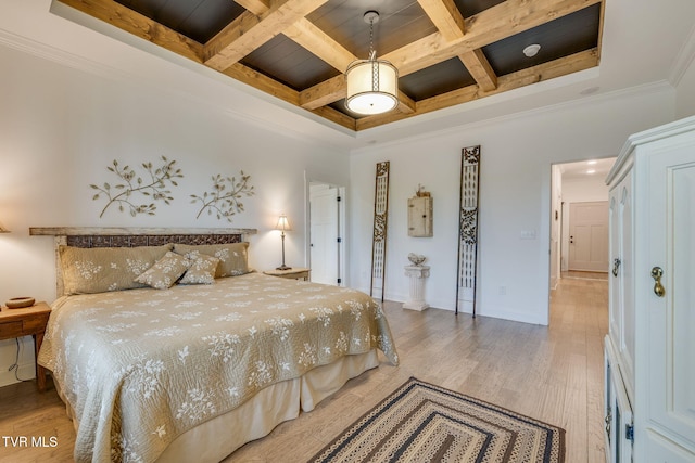bedroom with coffered ceiling, beam ceiling, light wood finished floors, crown molding, and baseboards