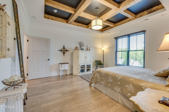 bedroom with light wood finished floors, beam ceiling, ornamental molding, coffered ceiling, and wooden ceiling