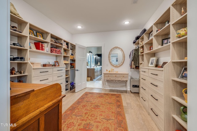 walk in closet featuring light wood finished floors