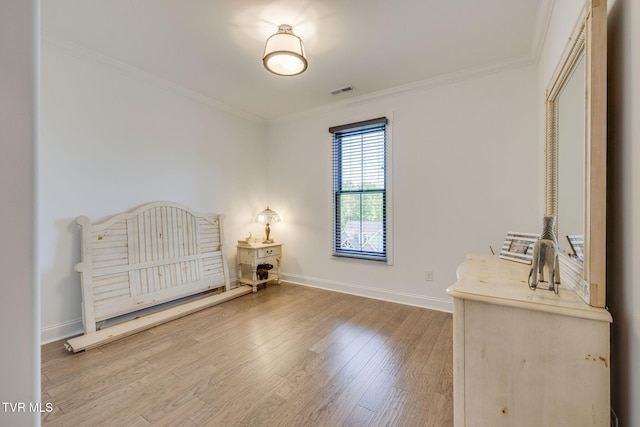 unfurnished bedroom featuring ornamental molding, baseboards, and wood finished floors