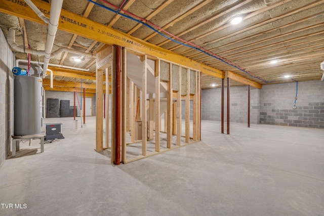 unfinished basement featuring water heater