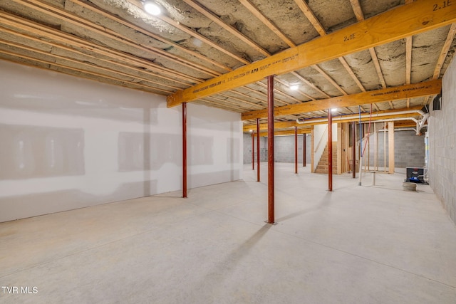unfinished basement featuring stairs