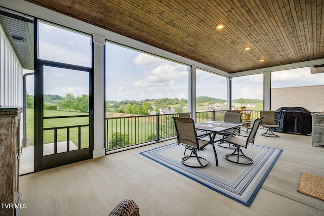 sunroom featuring outdoor dining space, wood finished floors, recessed lighting, wooden ceiling, and floor to ceiling windows