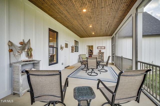 sunroom with outdoor dining space and recessed lighting