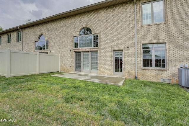 575 Boring Chapel Rd Unit 31, Johnson City, TN 37615 - back of property with central AC unit, brick siding, fence, and a lawn