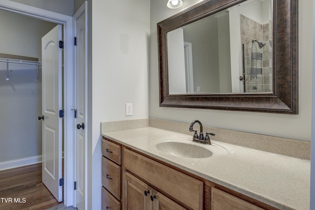 575 Boring Chapel Rd Unit 31, Johnson City, TN 37615 - full bath with baseboards, a tile shower, vanity, a walk in closet, and wood finished floors