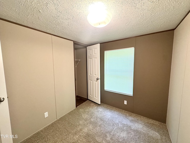 236 Redwood Dr, Raven, VA 24639 - unfurnished bedroom featuring a closet, a textured ceiling, ornamental molding, and carpet floors