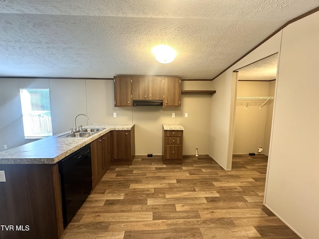 236 Redwood Dr, Raven, VA 24639 - kitchen with a textured ceiling, dishwasher, a sink, a peninsula, and wood finished floors