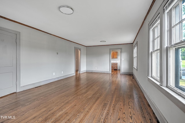 unfurnished room featuring baseboards, dark wood-style flooring, and ornamental molding