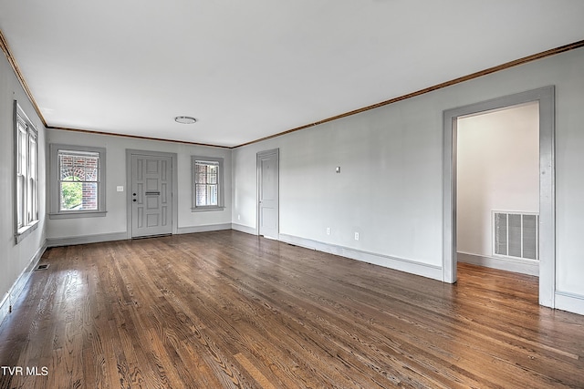 unfurnished living room with ornamental molding, baseboards, visible vents, and dark wood finished floors
