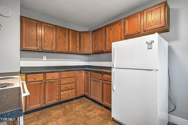 kitchen featuring brown cabinets and white appliances