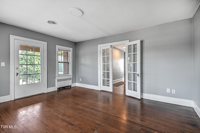 interior space featuring baseboards, radiator heating unit, french doors, and wood finished floors