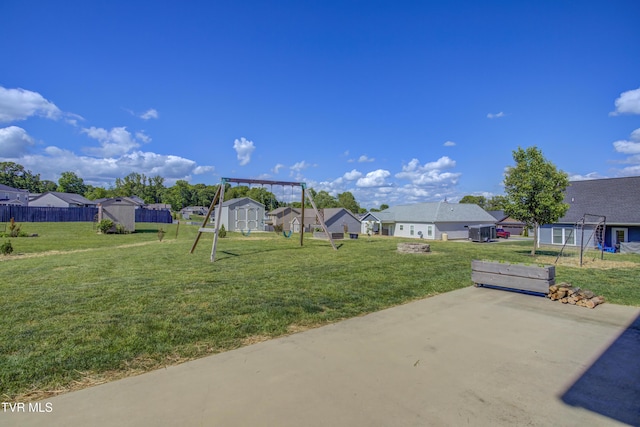 view of yard with a storage shed, an outbuilding, a patio area, and a residential view