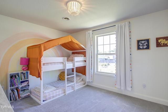 carpeted bedroom with multiple windows and baseboards