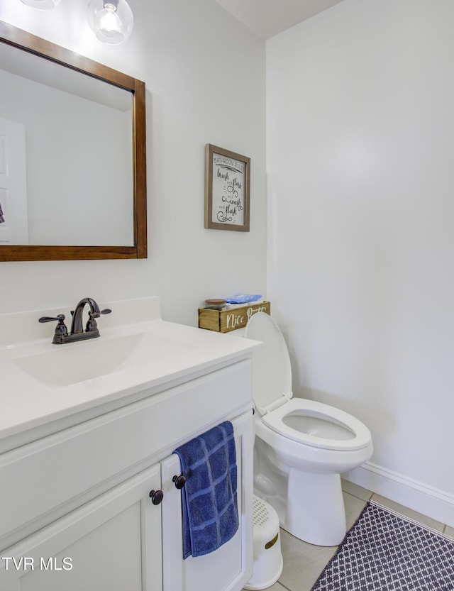bathroom with vanity, tile patterned flooring, and toilet