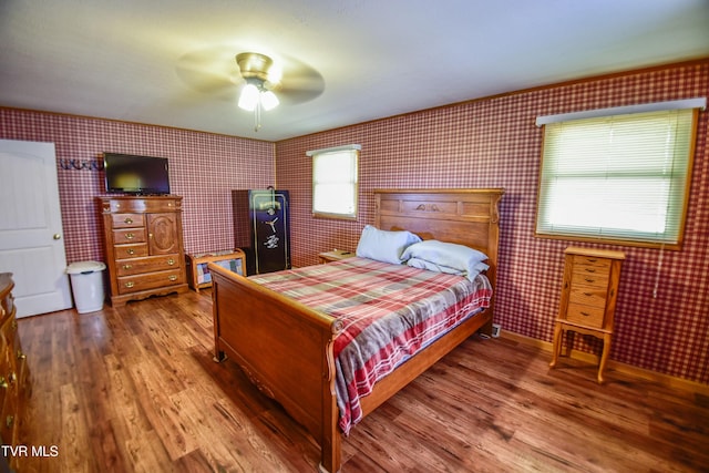 132 Hankal Rd, Gray, TN 37615 - bedroom featuring wallpapered walls, a ceiling fan, wood finished floors, and baseboards