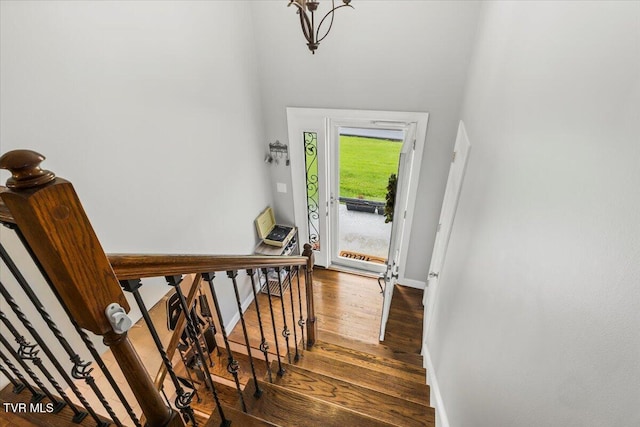 entryway with baseboards and wood finished floors