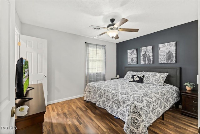 bedroom with dark wood finished floors, baseboards, and a ceiling fan