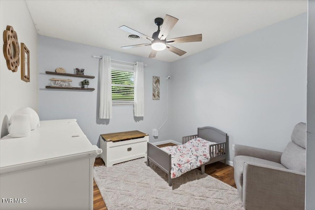 bedroom featuring baseboards, a ceiling fan, and wood finished floors
