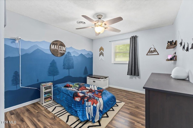bedroom featuring baseboards, a ceiling fan, and wood finished floors