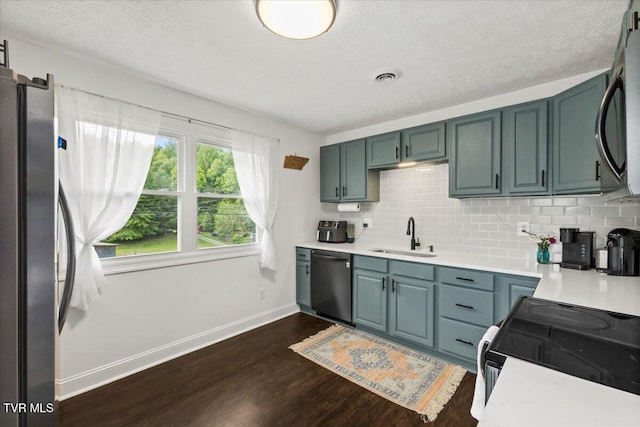 kitchen featuring dishwasher, baseboards, electric range oven, a sink, and light countertops