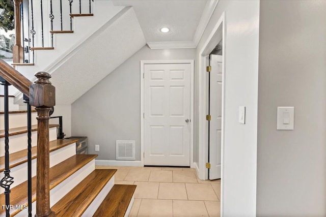 entryway with recessed lighting, visible vents, baseboards, and stairs