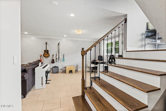 staircase featuring a textured ceiling, tile patterned flooring, ornamental molding, and recessed lighting