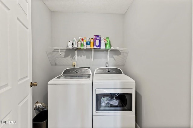 washroom with washing machine and clothes dryer and laundry area