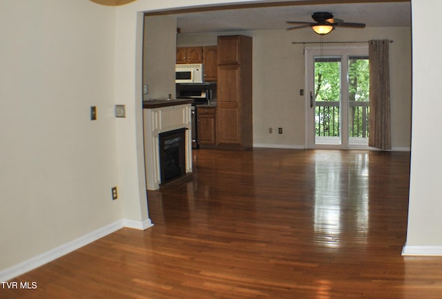 2700 Indian Ridge Rd Unit 23, Johnson City, TN 37604 - unfurnished living room with baseboards, dark wood-style flooring, ceiling fan, and a fireplace