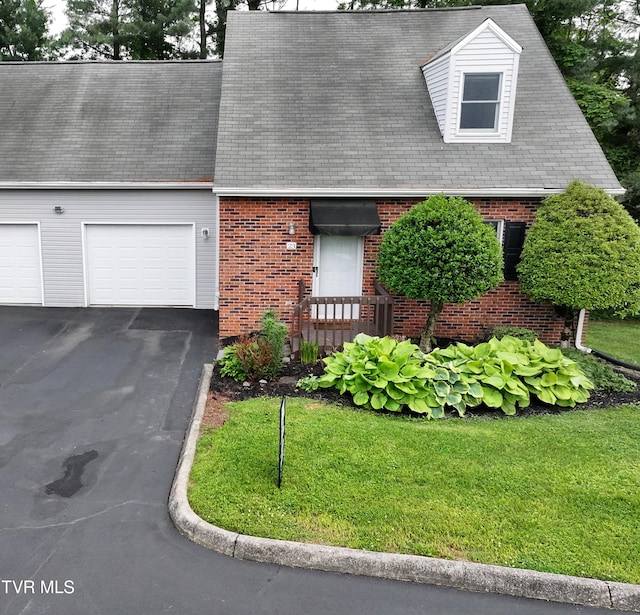 2700 Indian Ridge Rd Unit 23, Johnson City, TN 37604 - cape cod home with brick siding, driveway, an attached garage, and a front yard