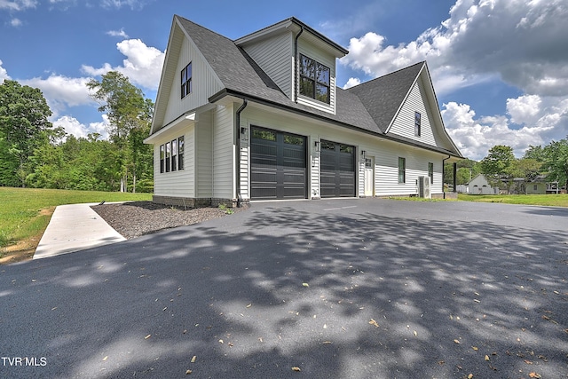 view of home's exterior with driveway, a shingled roof, and an attached garage